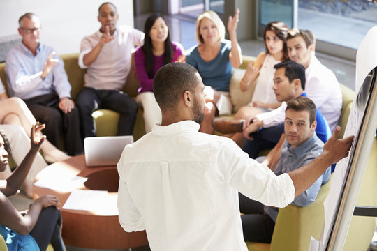 Businessman Making Presentation To Office Colleagues