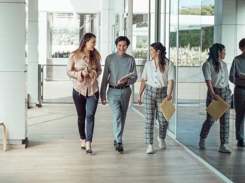 Three coworkers walking and talking