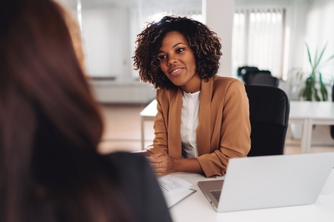 Woman looking at a coworker and smiling